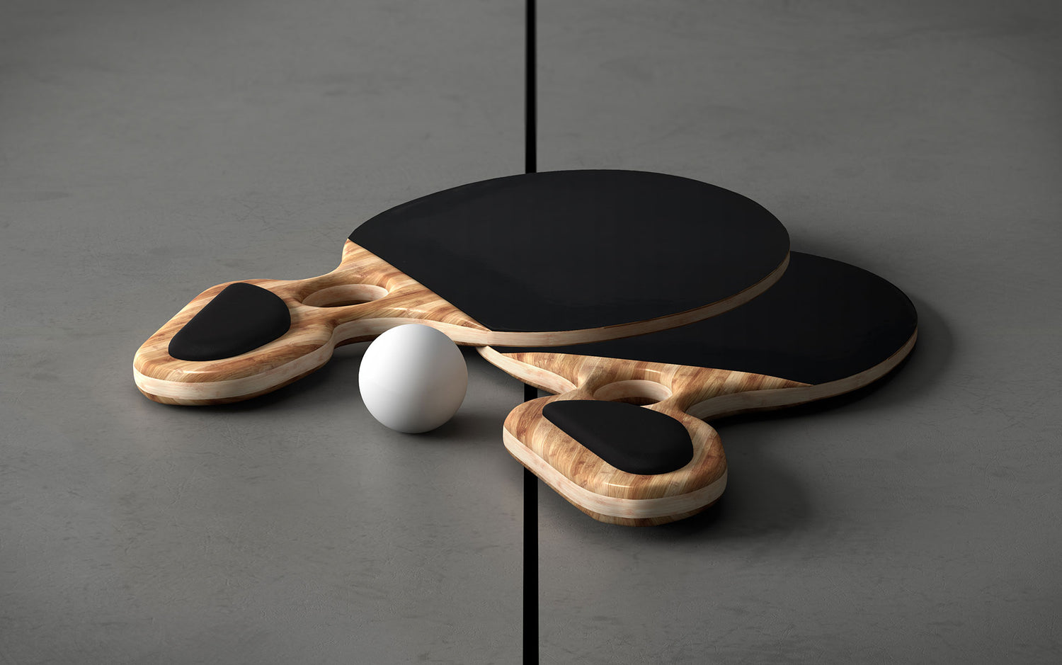 Two ping pong paddles sitting next to a ball on a grey table.