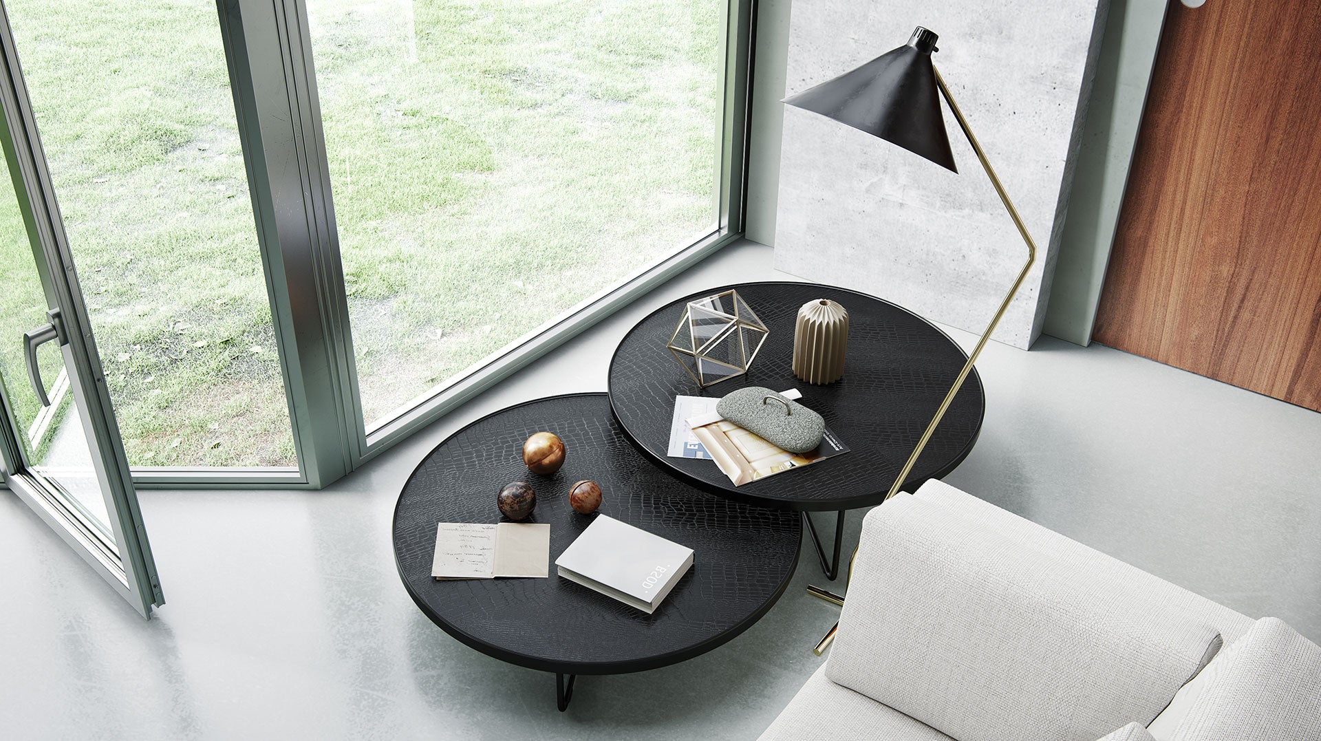 A modern wooden coffee table in front of a grey couch.